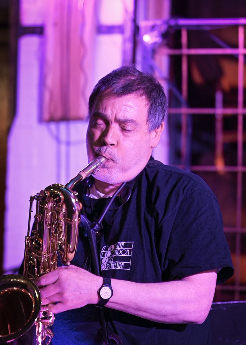 A jazz musician passionately playing a baritone saxophone