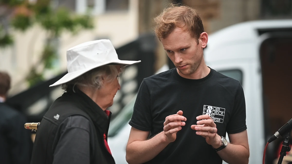 A jazz musician in an administrative role, helping the band to prepare