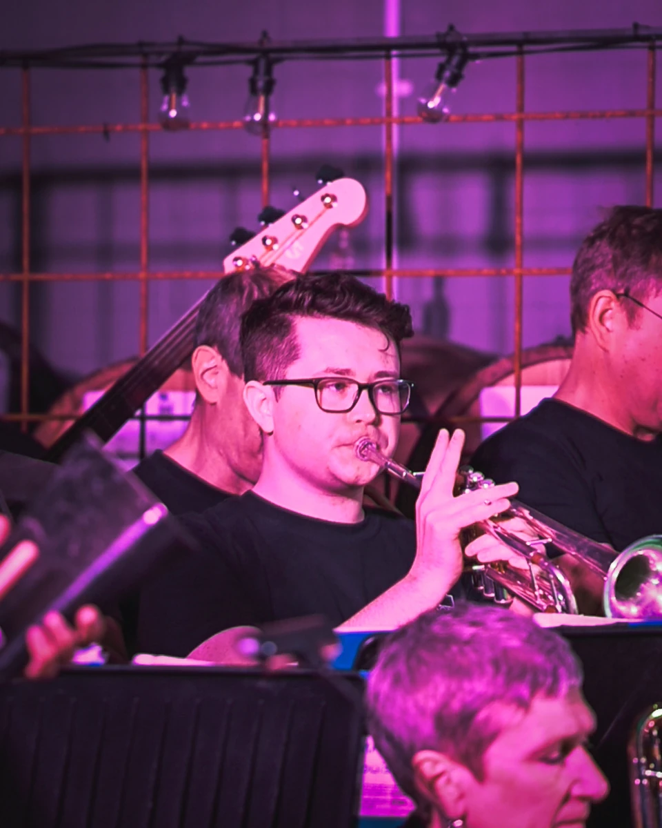 A jazz trumpet player performing in a tight corner