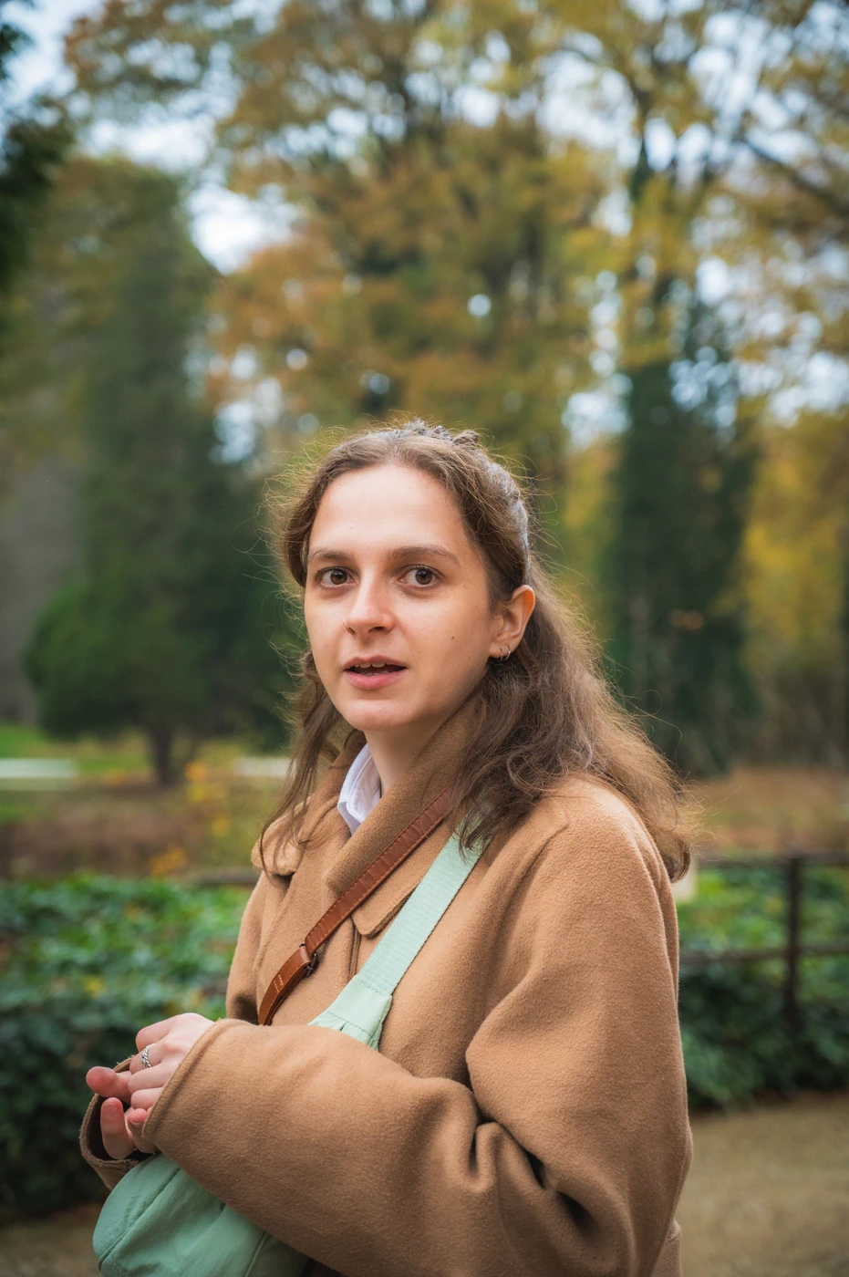 Woman in a garden turning to face the camera