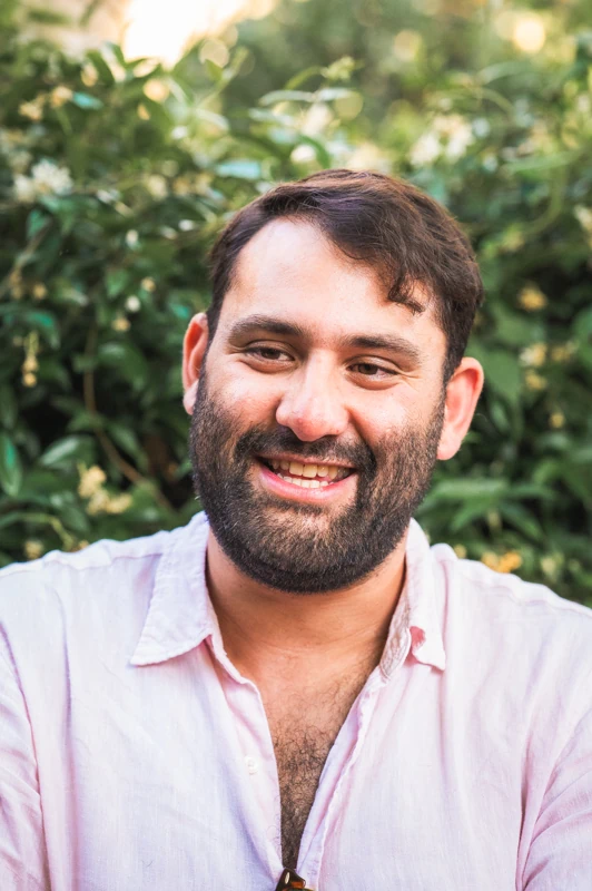 A man laughing and smiling during a burst shot: 1/5
