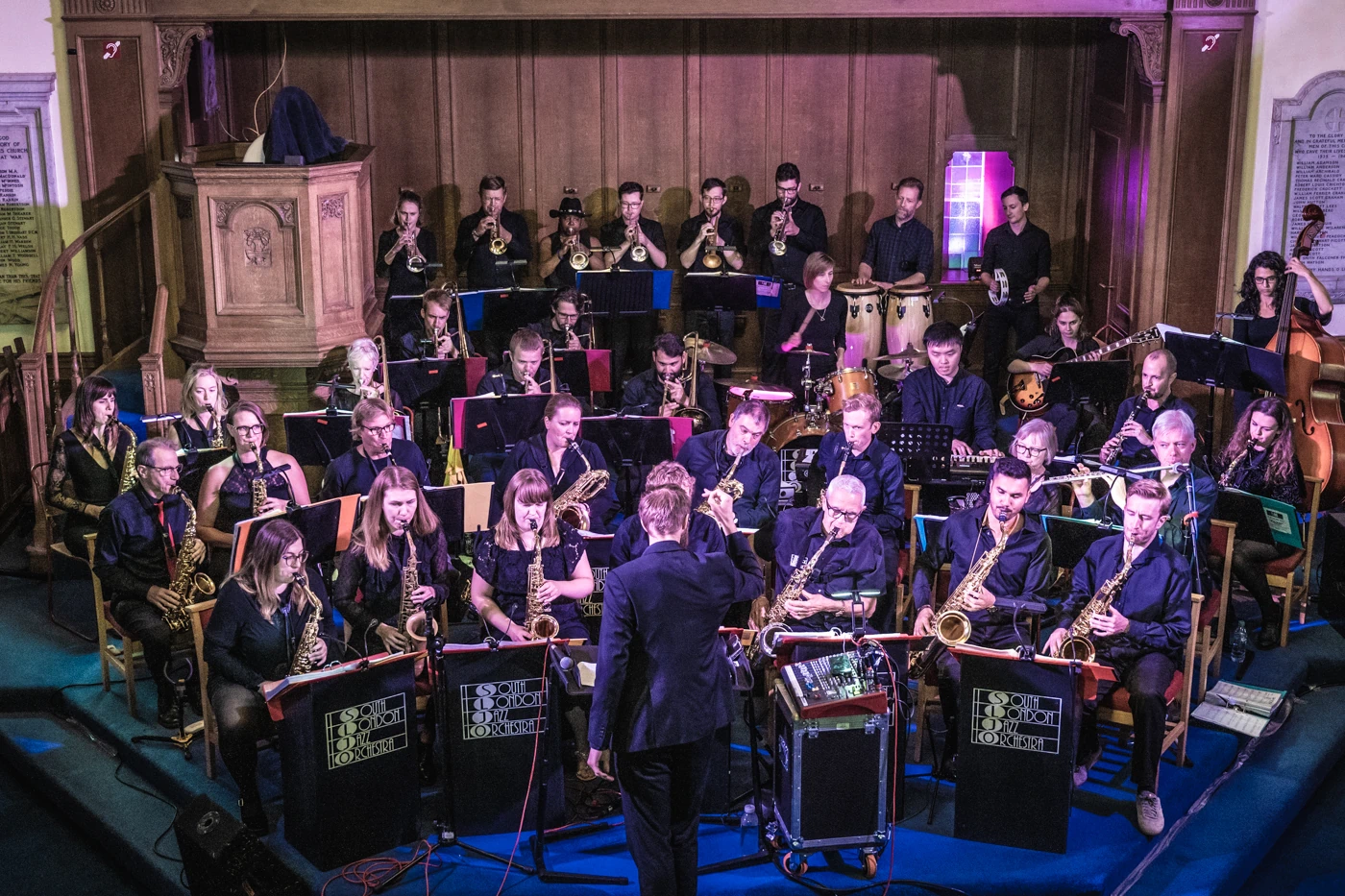 A shot from up high of a big band playing in a church.